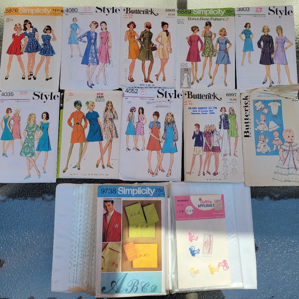 11 vintage sewing patterns and a package of vintage appliques